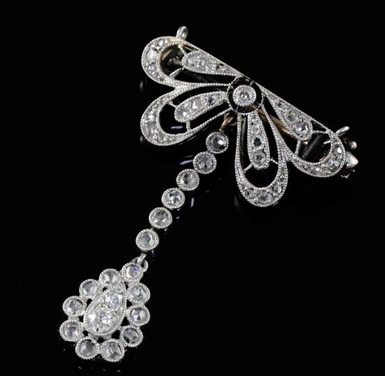 A 1920s pierced platinum? and millegrain set diamond drop brooch, 3cm.